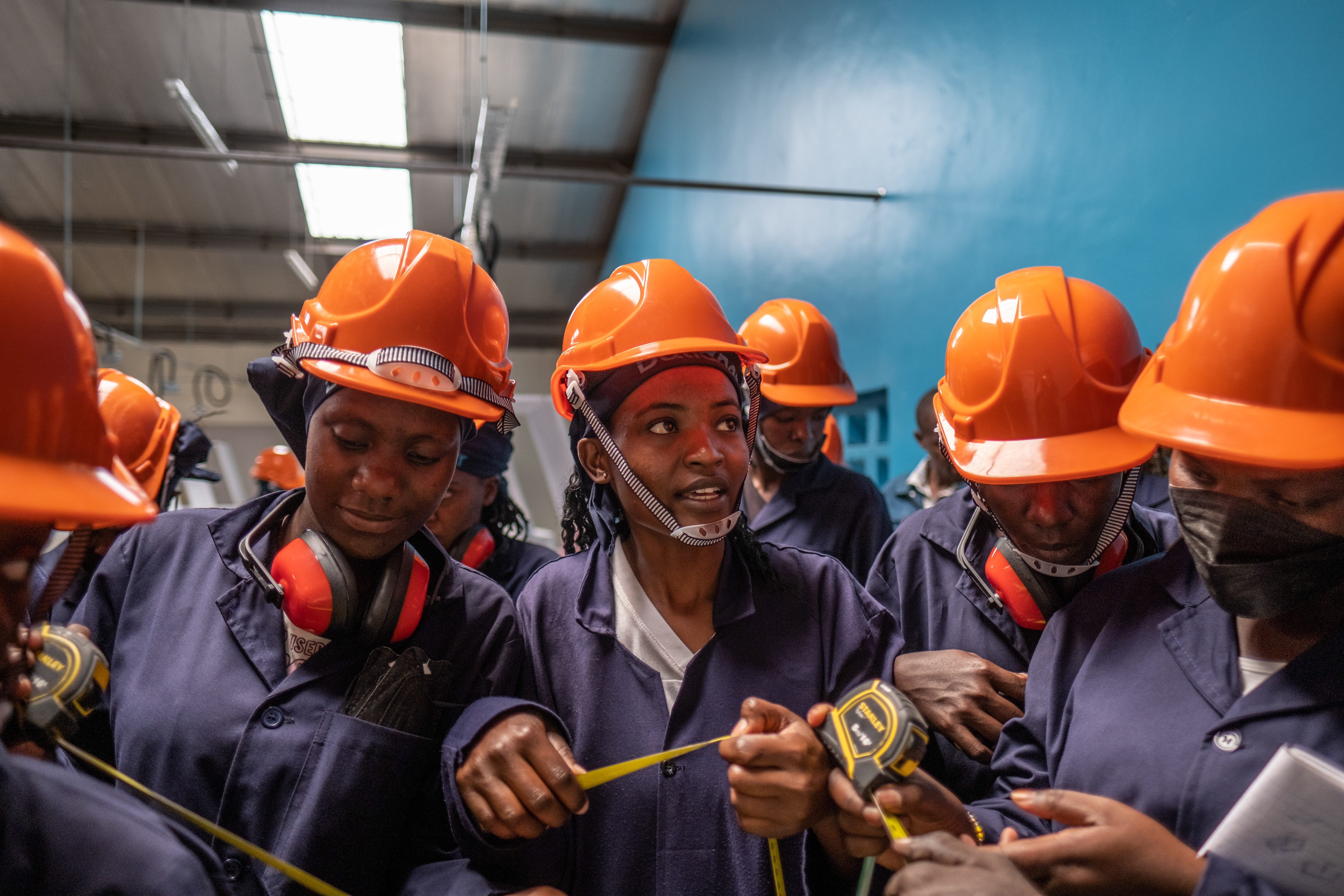 Students take part in a tiling class at the Buildher training facility in Nairobi, Kenya.